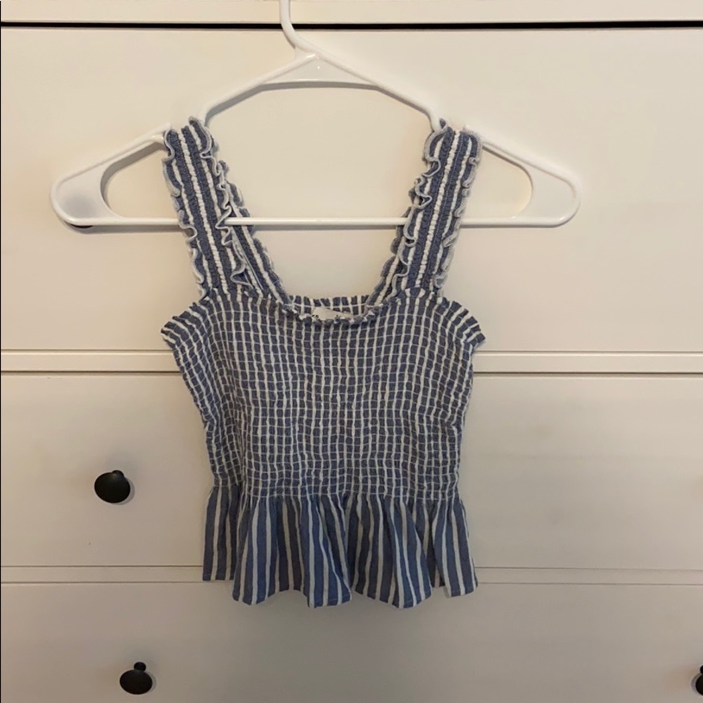 A blue and white stripes smocked peplum top